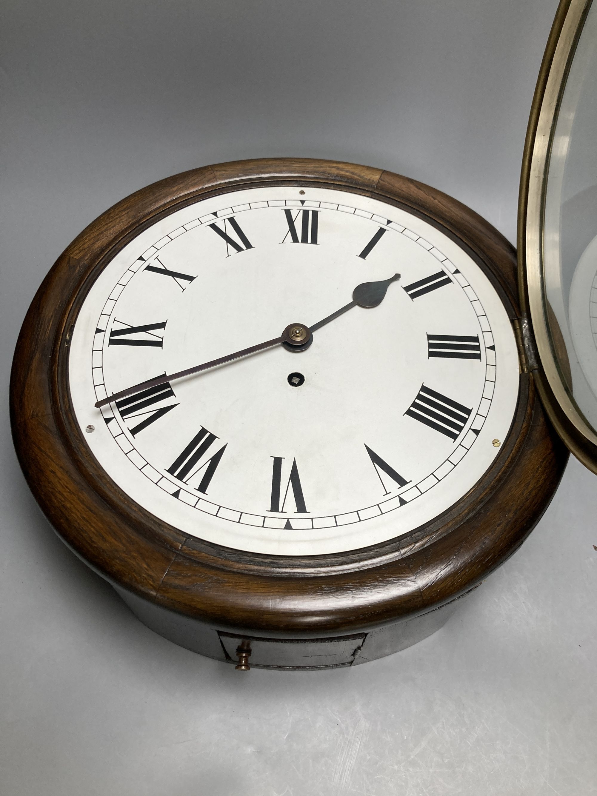 An oak cased single fusee dial wall clock, black Roman numerals on a white 12